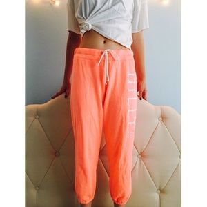 Gilly Hicks neon peach sweatpants in small.